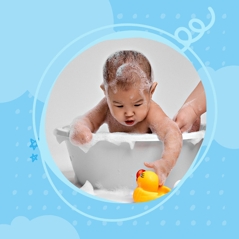 A banner image of baby care where a baby is playing in a bath tab covered with shampoo.