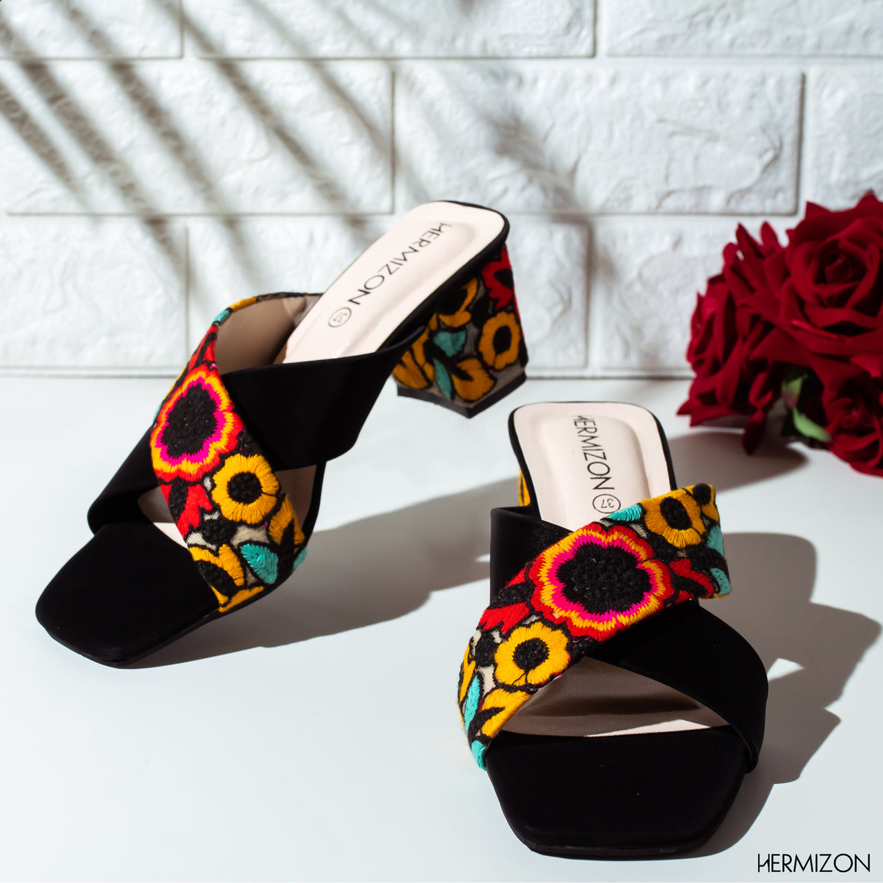 A black color semi heel shoe with colorful design