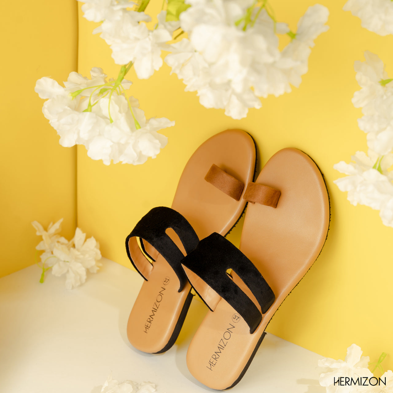 A pair of brown color flat sandals