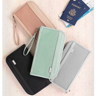Four travel wallets in different colors with a passport and tickets on a light background