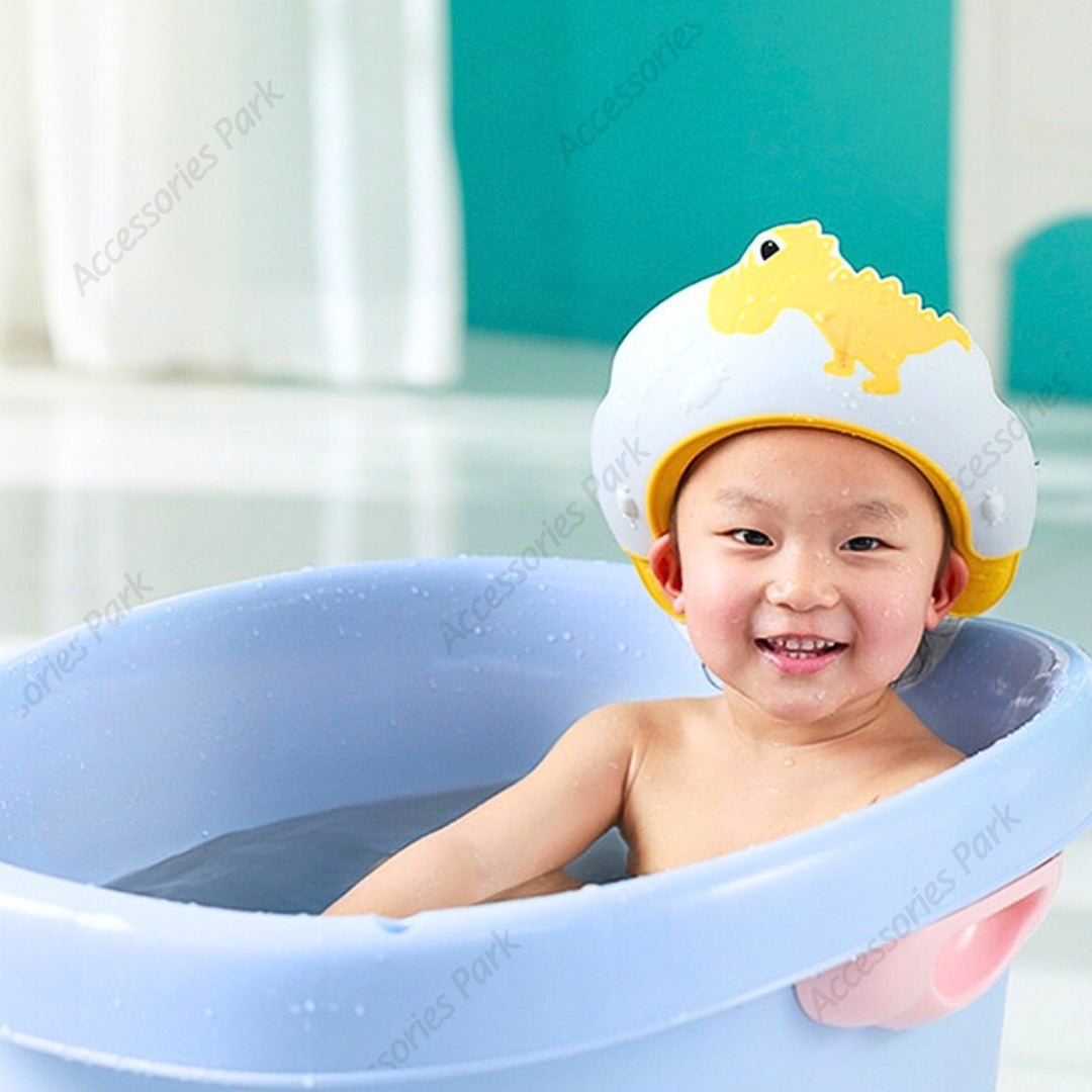 A baby is having shower with a yellow color cap which protects from getting wet.