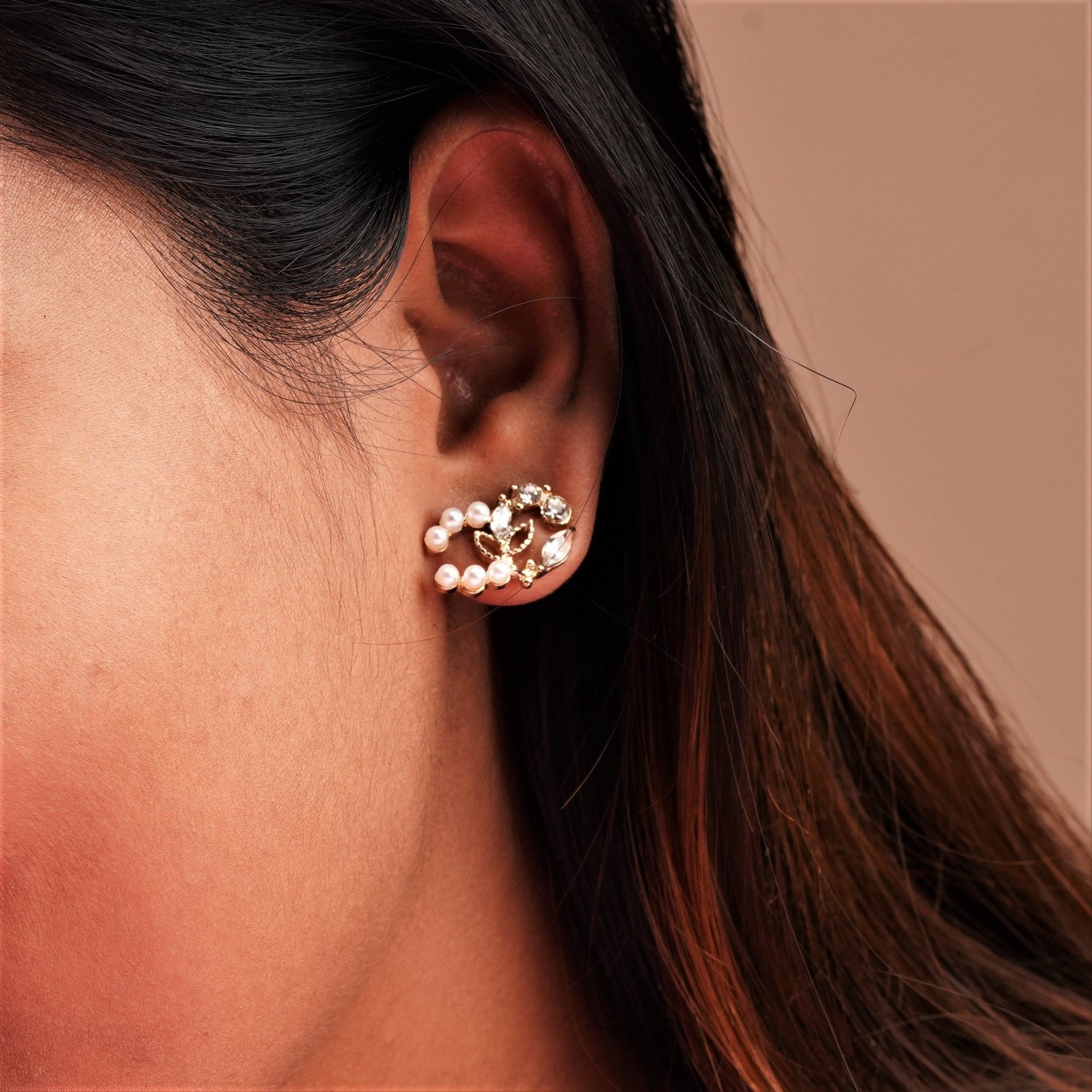 A pearl beaded earring on a girl's ear