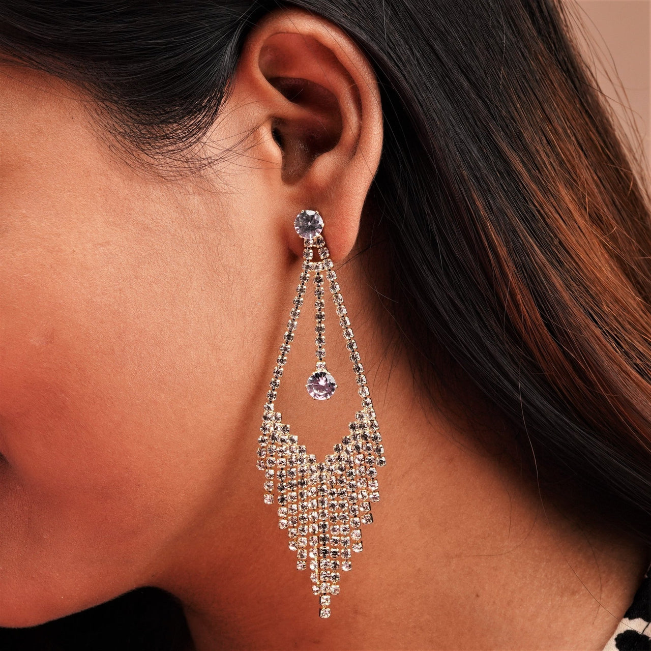 Stone cut stylish design earrings on a girls ear