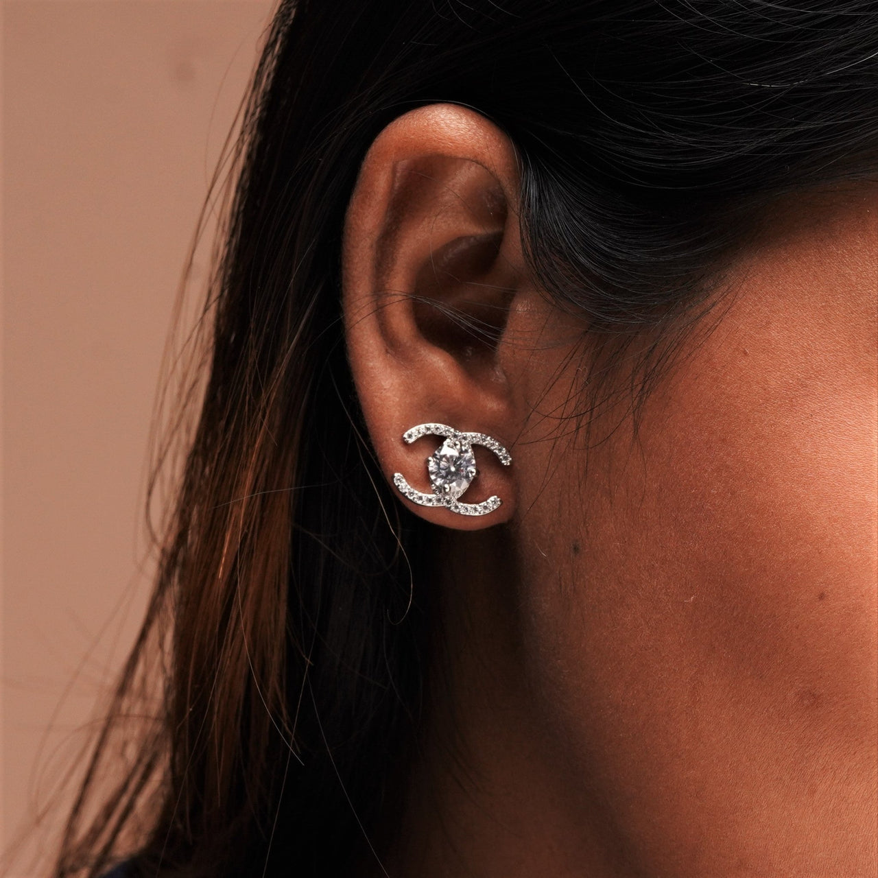 A silver color Earring on a girl's ear