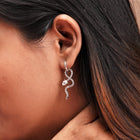 A snake design earring on a girls ear