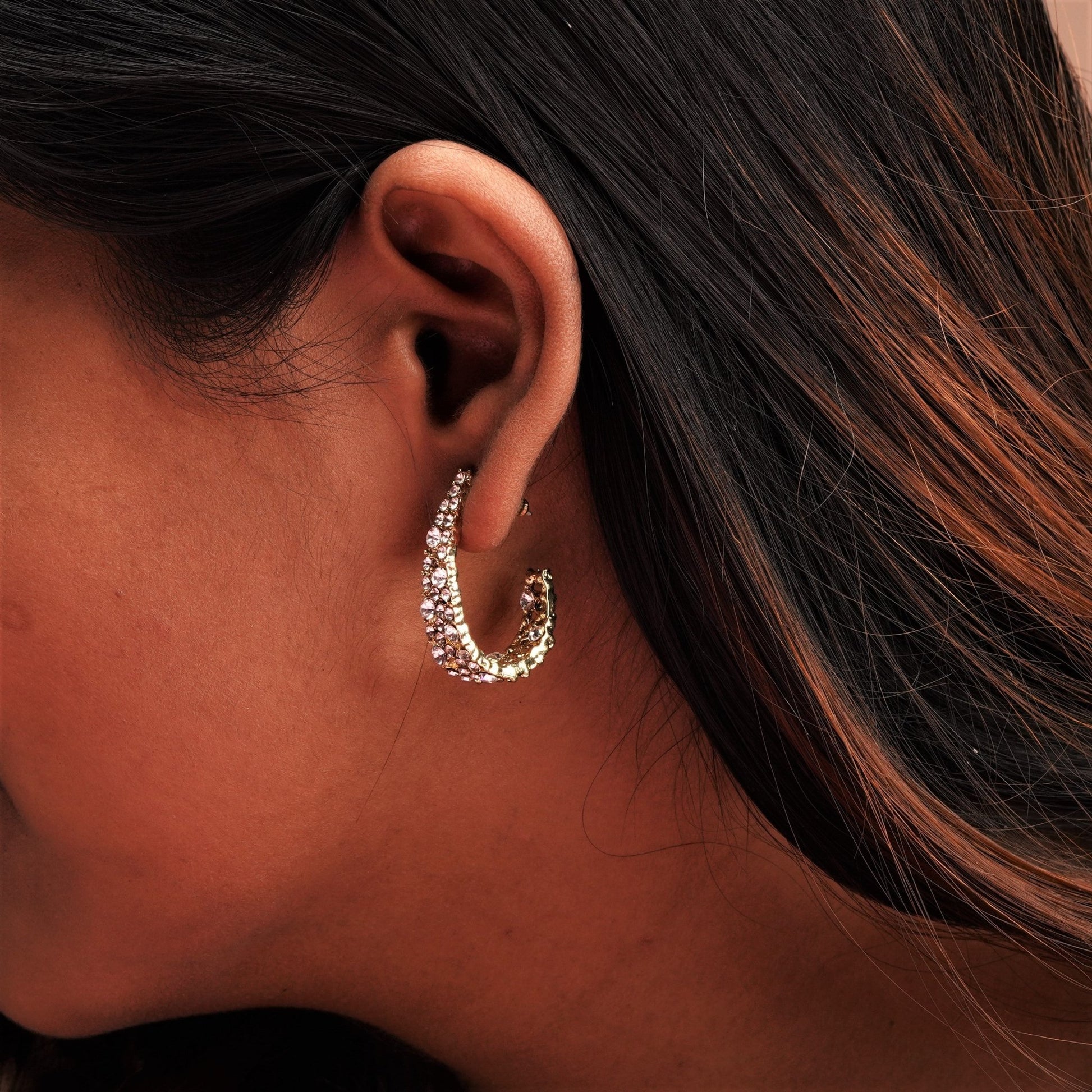 A stylish design earring on a girl's ear