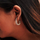 A stylish design earring on a girl's ear