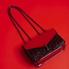 A red color party bag with sparkle