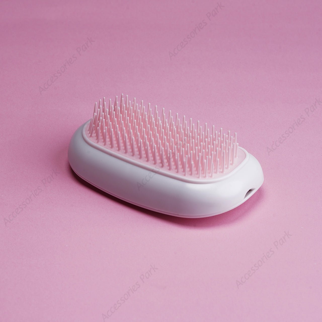 A pink color electric hair brush in white body