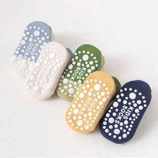 Colorful slippers with text in a language other than English on a white background