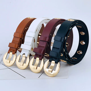 Set of five belts in different colors with gold buckles on a light gray background