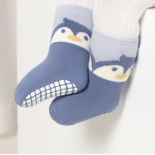 Blue penguin socks with white sole on a light background