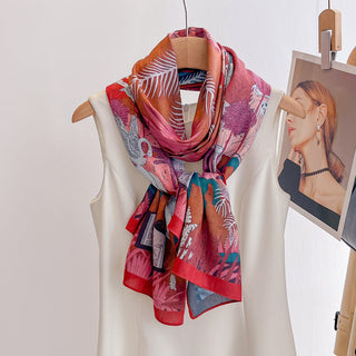 Colorful patterned scarf draped over a white dress on a hanger with a blurred portrait in the background.