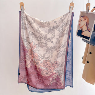 Floral patterned scarf hanging on a clothesline with a coat and photo in the background.