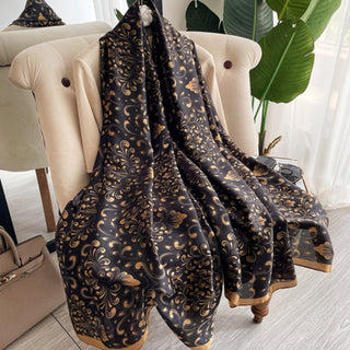 Patterned scarf displayed on a chair with a neutral background