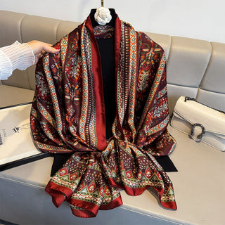 Decorative patterned scarf on a mannequin against a neutral background