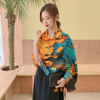 Woman wearing a colorful scarf in an indoor setting with a palm tree.