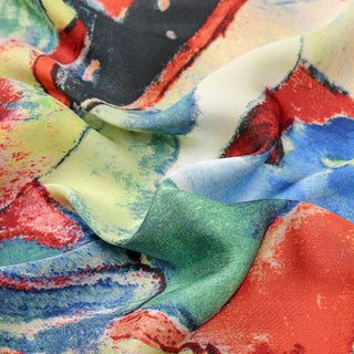 Close-up of colorful fabric with abstract patterns in red, blue, green, and yellow.