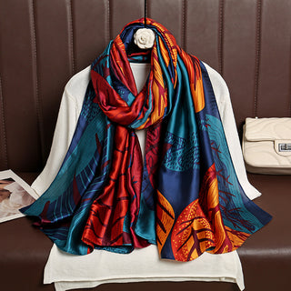 Colorful patterned scarf draped over a mannequin against a brown leather background.