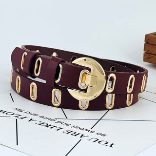 Brown belt with gold hardware on a white surface