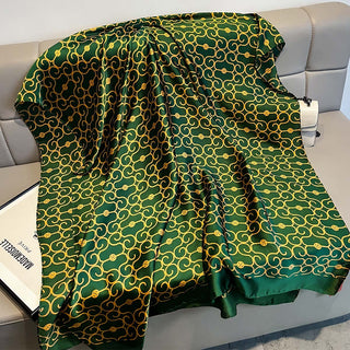 Green and gold patterned fabric draped over a surface with a neutral background