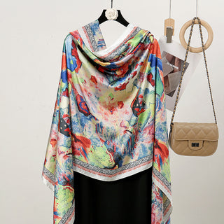 Colorful scarf with abstract patterns draped over a hanger next to a beige handbag on a white background