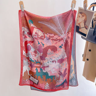 Colorful scarf with animal and nature design hanging on a rack