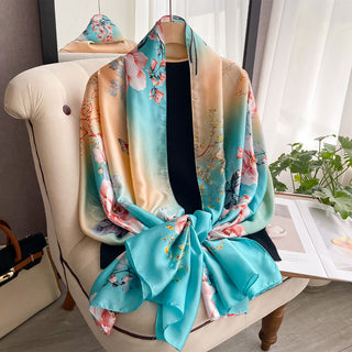 Floral patterned scarf draped over a chair in a room with a window and plant.