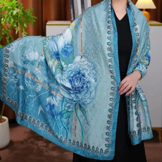 Woman wearing a blue floral shawl in an indoor setting